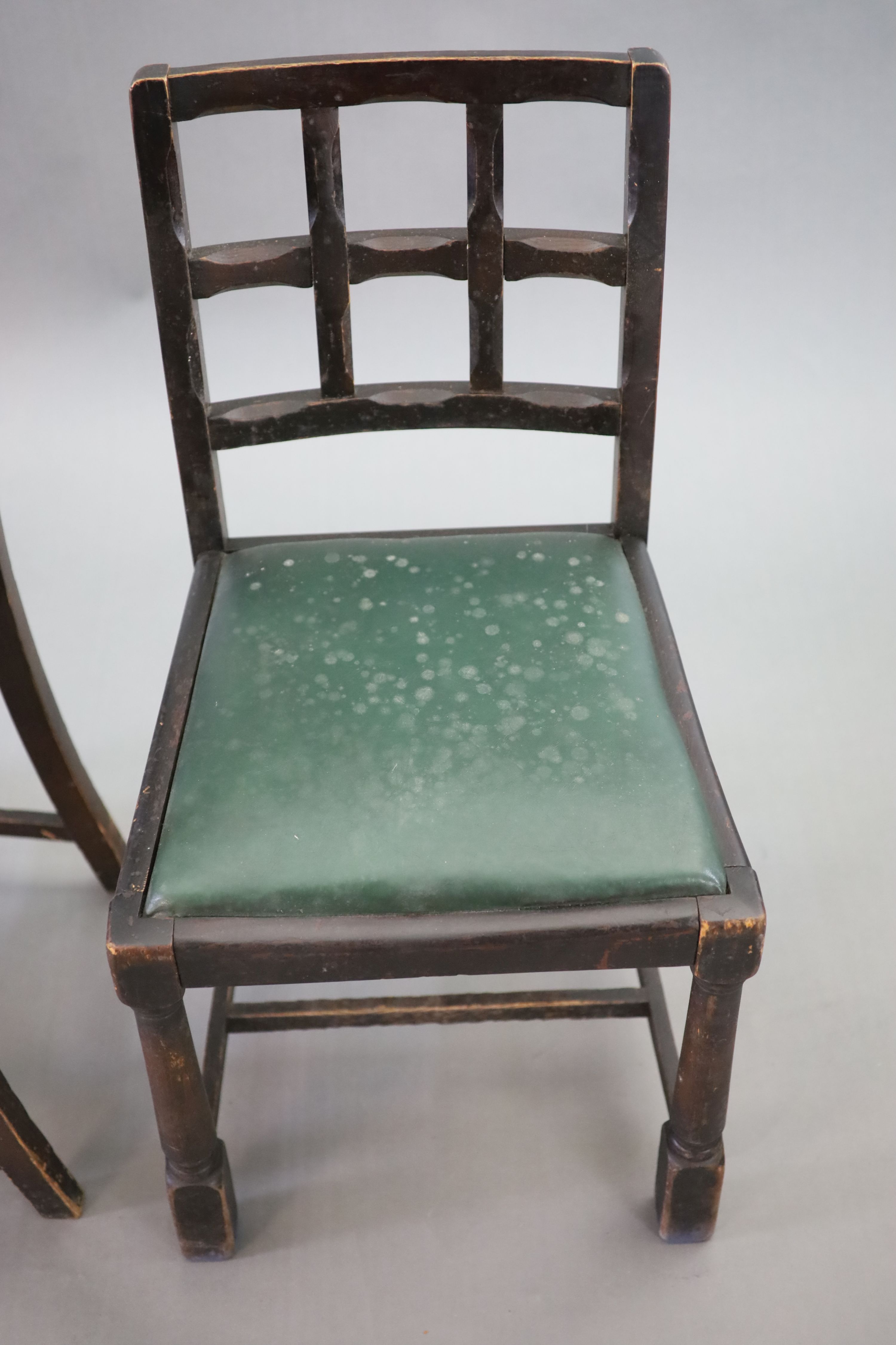 A set of twelve stained beech and oak dining chairs, with cross frame backs and drop-in seats, on turned and squared legs